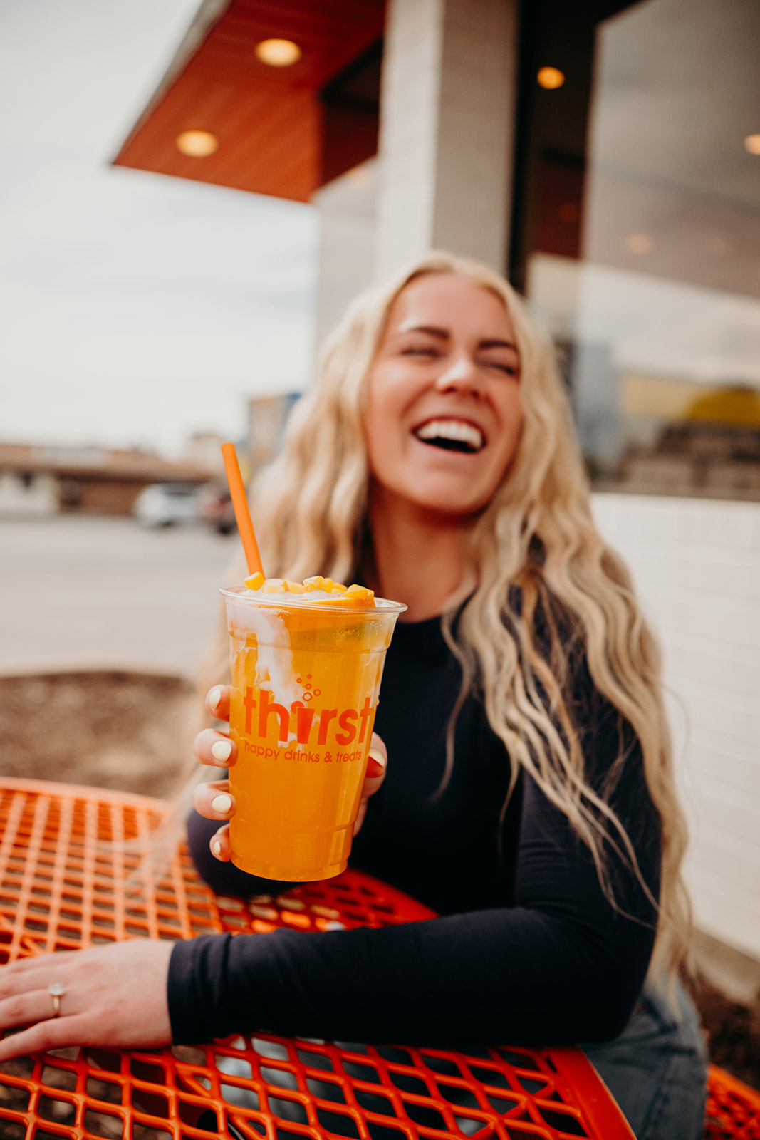 A customer laughing with a Thirst drink