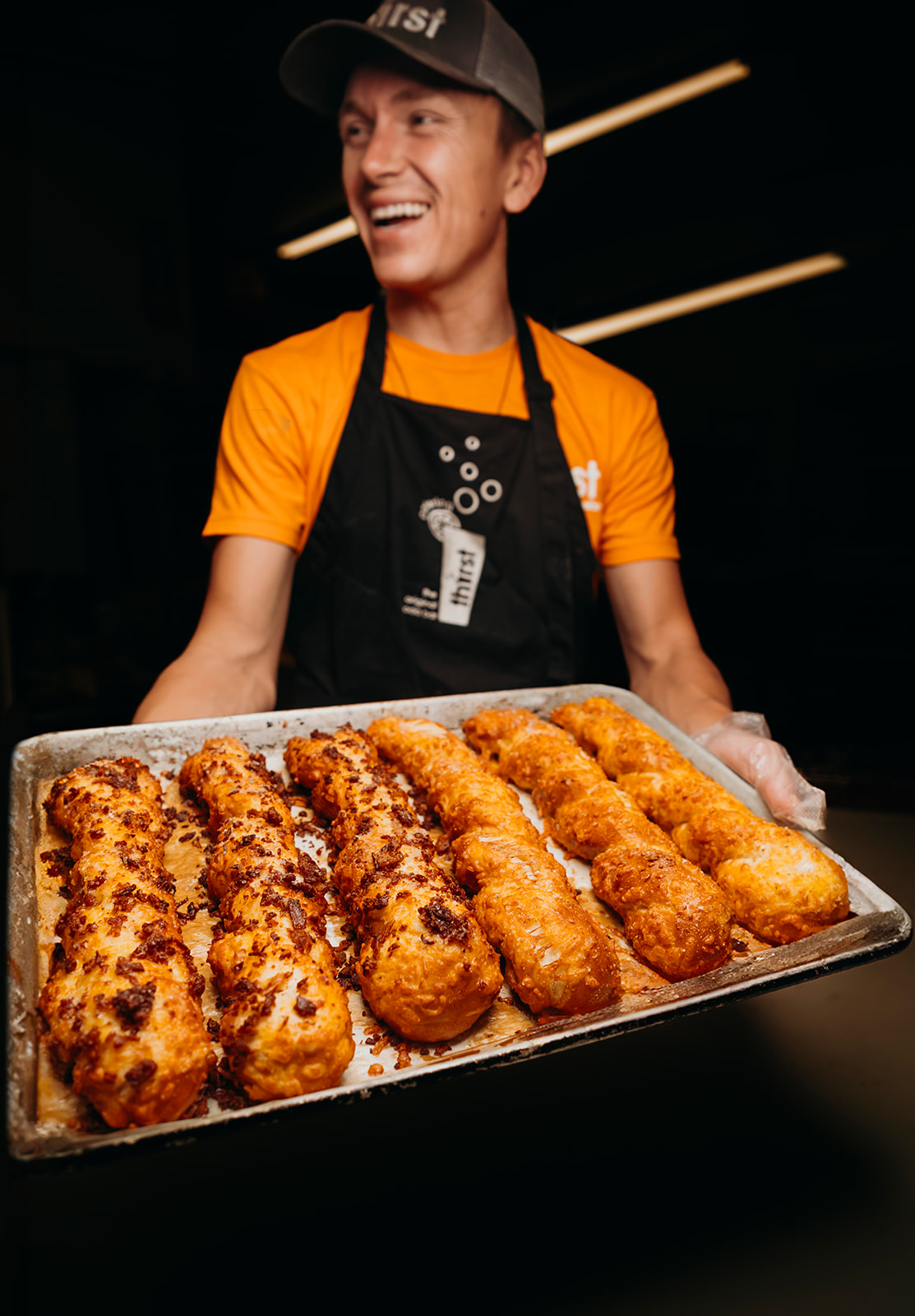 Ethan smiling with a tray of fresh pretzel twists
