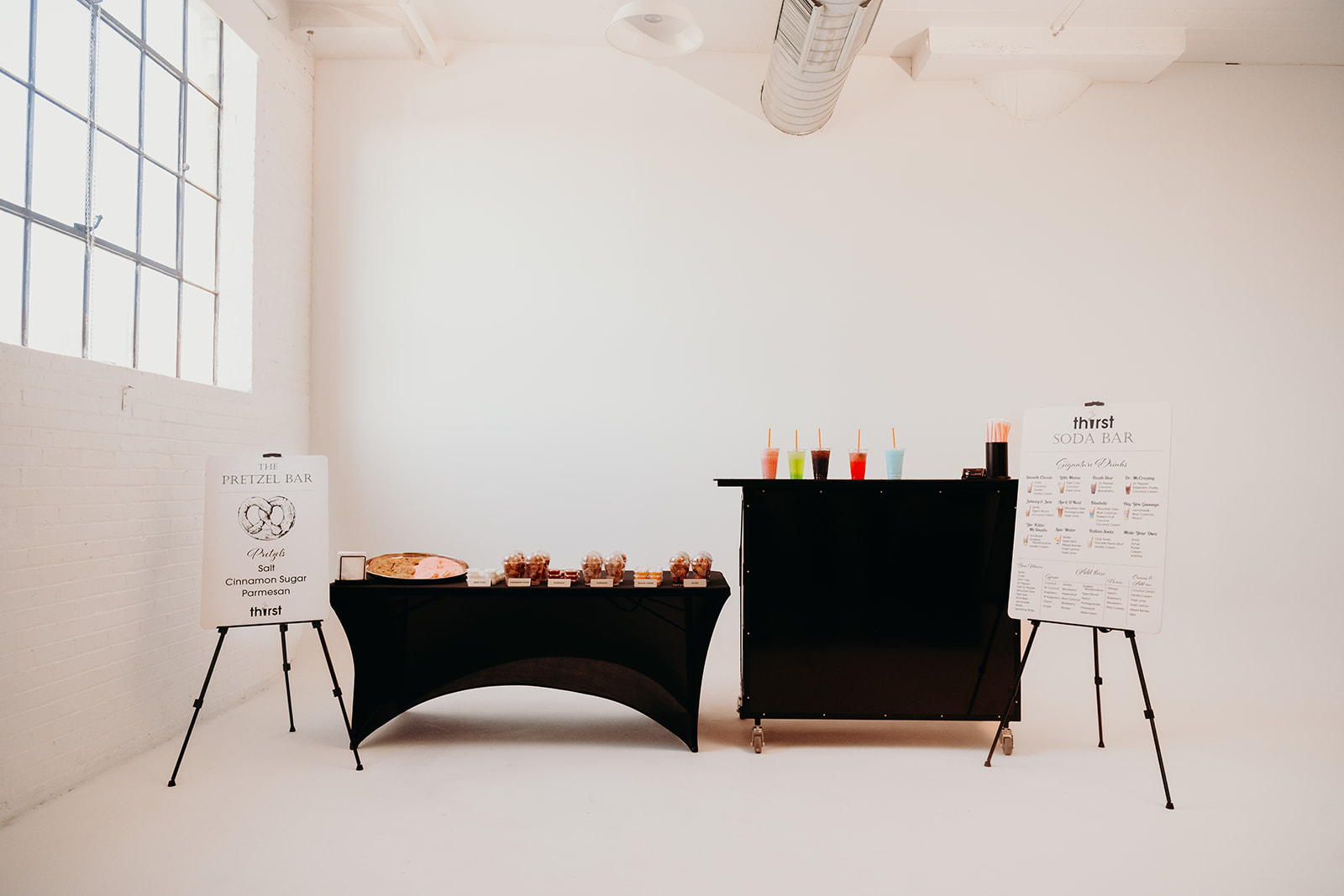 A full Thirst catering setup with the Pretzel Bar and Soda Bar at a corporate venue