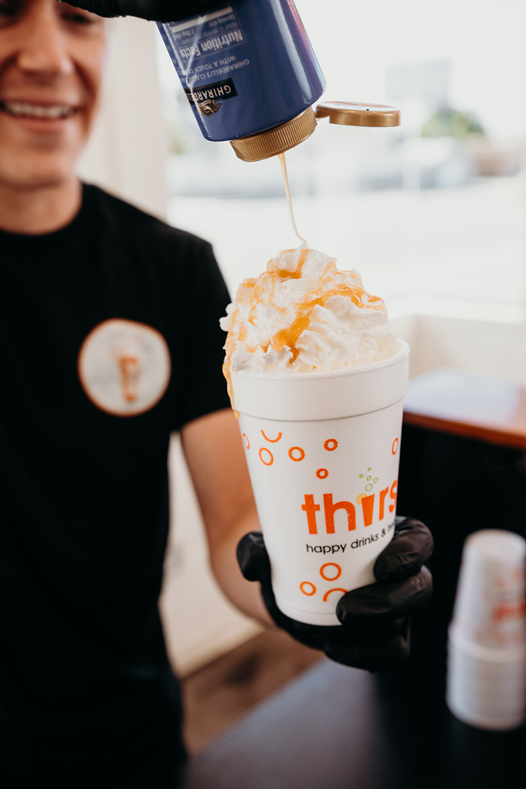 Caramel drizzled over a whipped cream hot chocolate