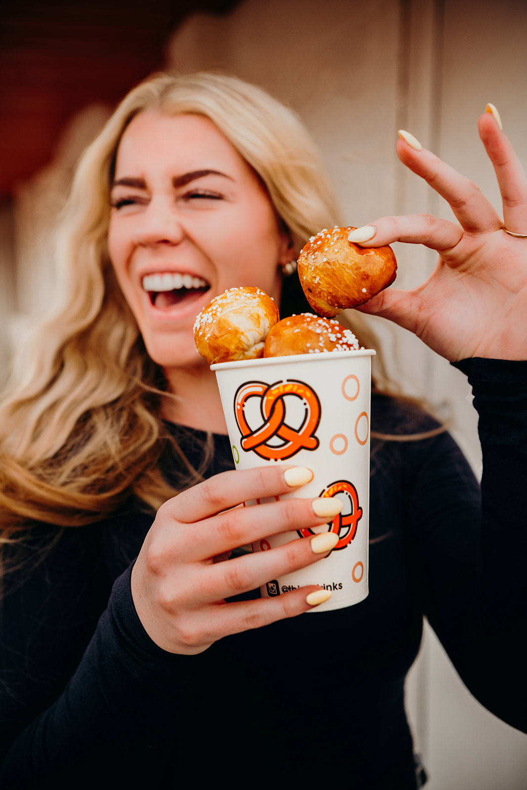 A customer with a cup of pretzel bites